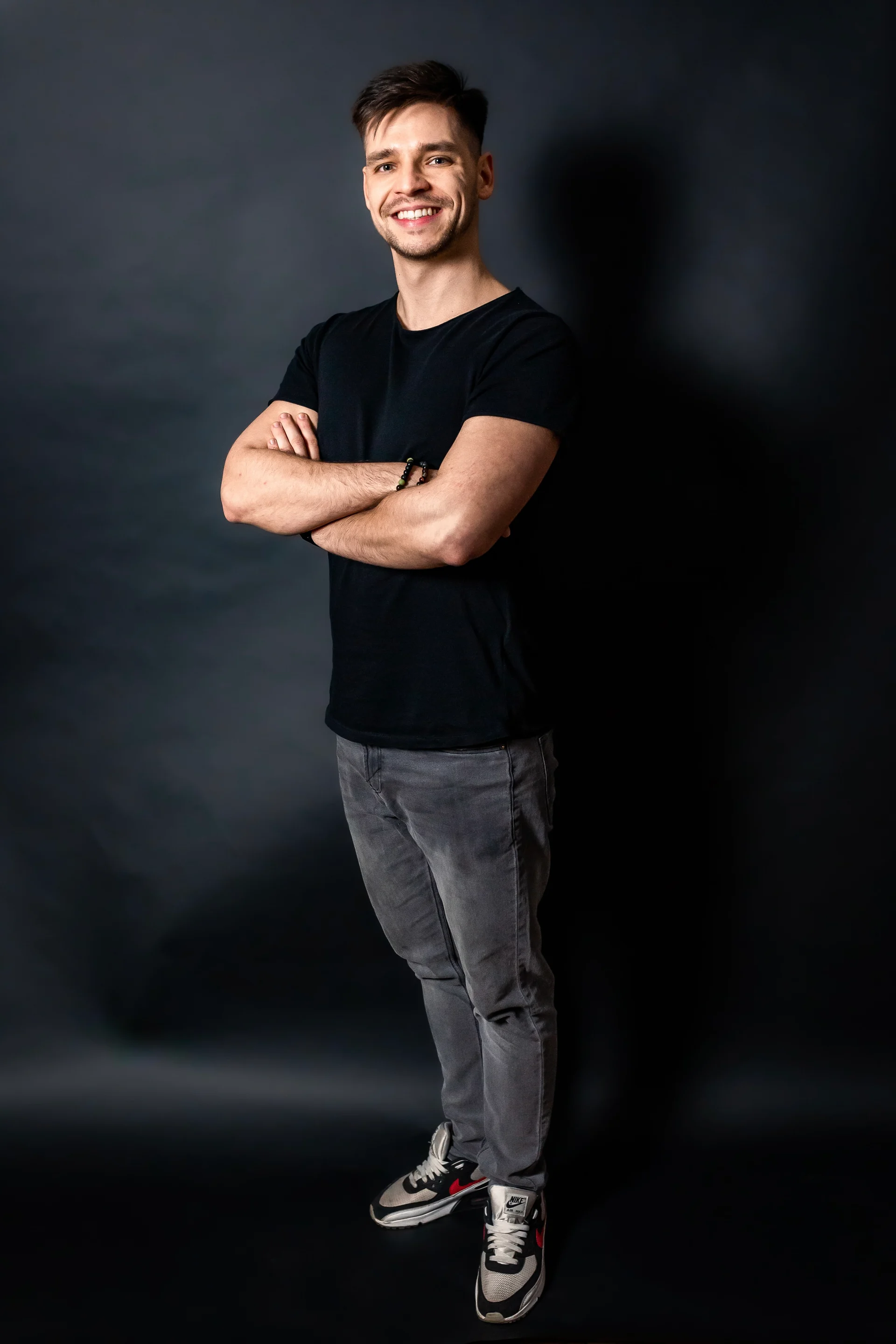 Subrage standing in a black T-shirt against a dark studio background